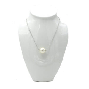 A Faux Pearl Floats on a Silver Tone Chain