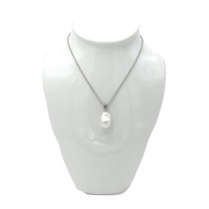 A Large Baroque Pearl Dangles from a Silver Tone Chain