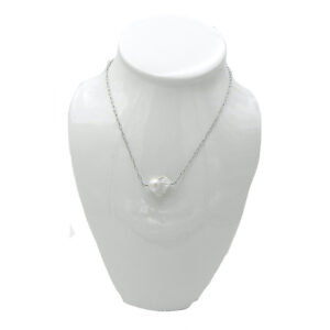 A Large Baroque Pearl Floats on a Silver Tone Chain