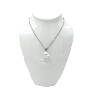 A Large Baroque Pearl Dangles from a Silver Tone Chain