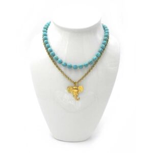 The Wisdom of the Elephant Dangles from a Mixed Metal Chain and a Background of Turquoise Dyed Howlite